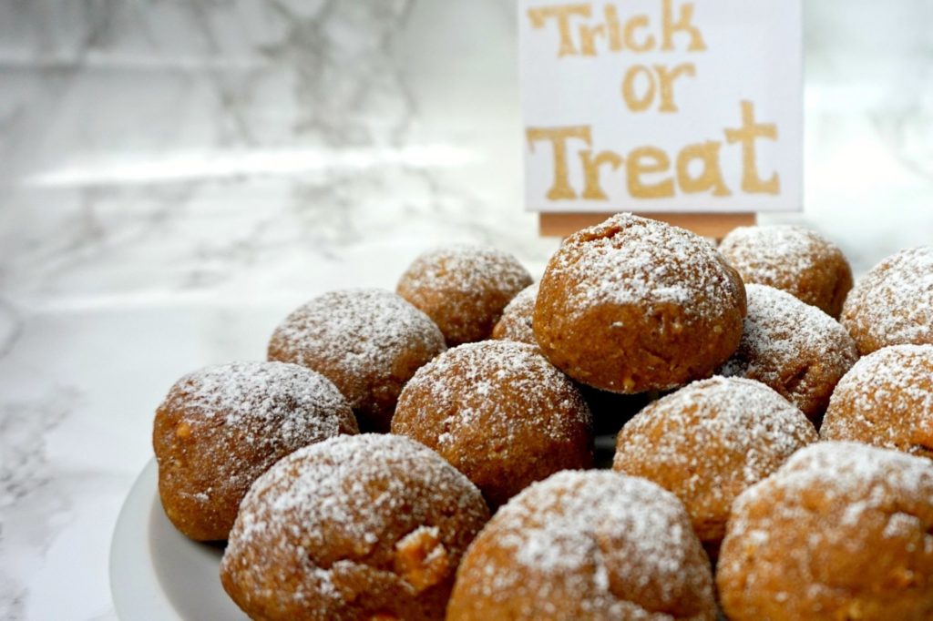 Halloween pumpkin spice cookies with a sign in the background saying "Trick or Treat".