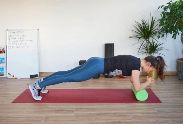 Girl Doing Plank Exercise on a Foam Roller during the Foam Roller 15 Minutes Abs Workout