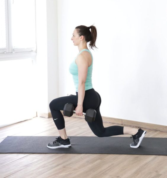 Athletic woman demonstrating reverse lunge dumbbell exercises part of a dumbbell Crossfit workouts list.