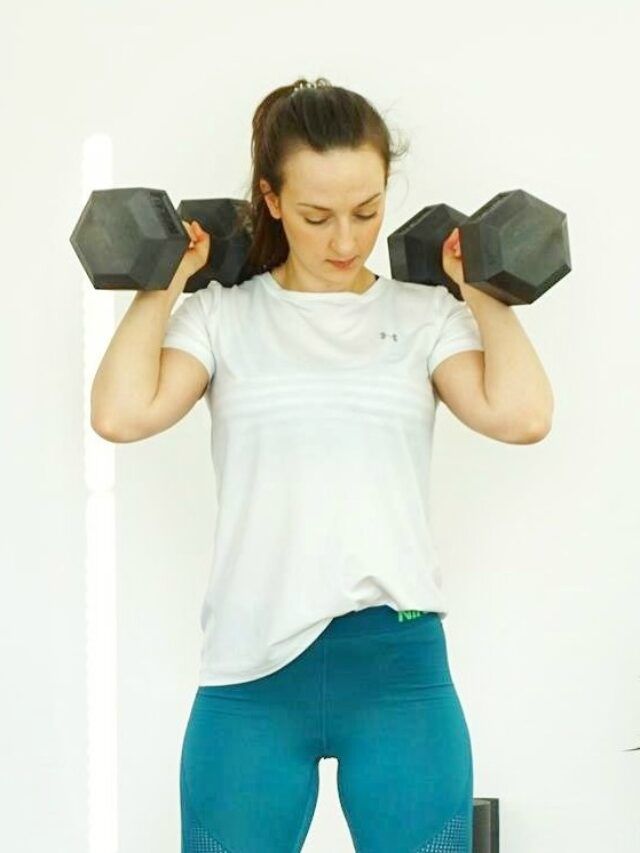 Girl holding dumbbells ready for a HIIT workout