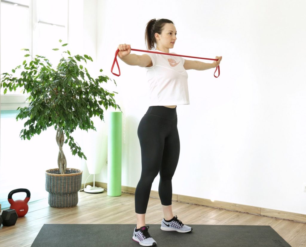 resistance band pull-aparts exercise part of an upper body resistance band home workout
