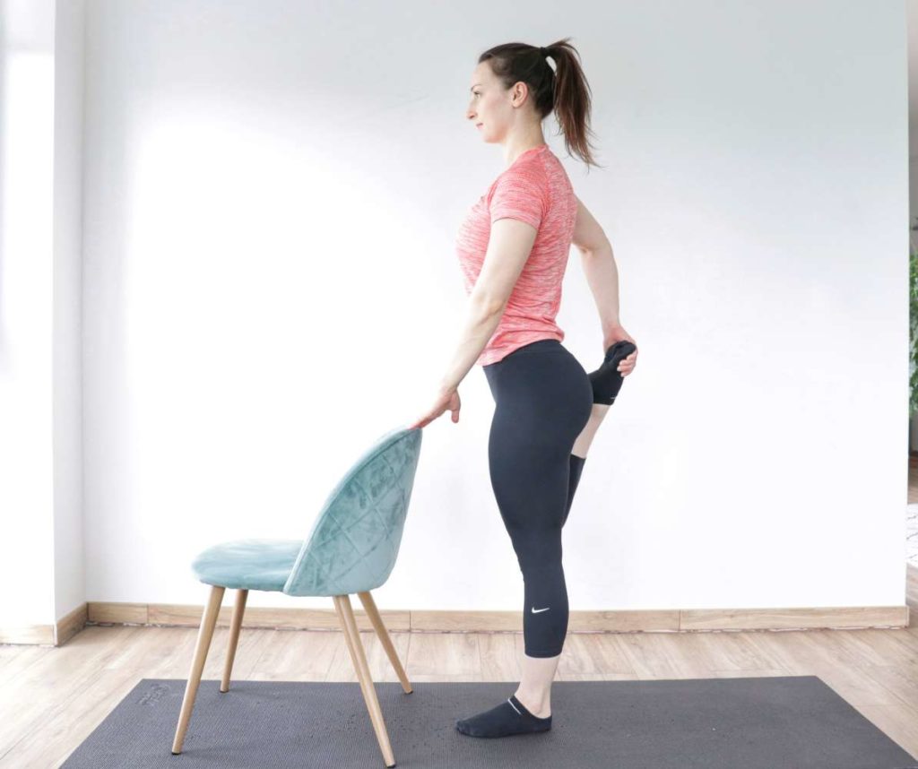 Standing quad stretch demonstration to relieve tight hip flexors.