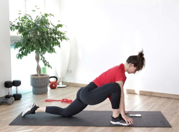 image of a girl doing a full-body warm-up for home workouts